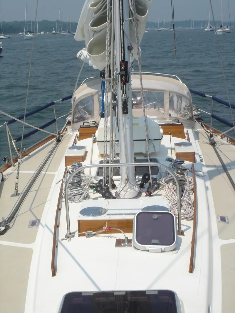 Slide: The Image of 1980 Hinckley 43 sailboat deck with rigging and ropes on a calm sea. - 4