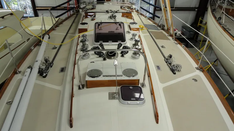 Slide: The Image of 1980 Hinckley 43 sailboat deck with winches and hatches in a storage facility. - 42