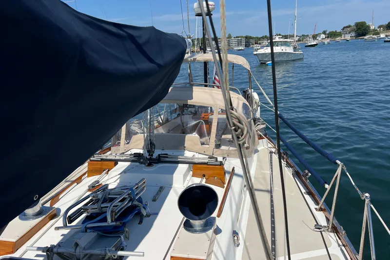 Slide: The Image of 1980 Hinckley 43 sailboat on calm water, featuring deck and rigging details. - 45