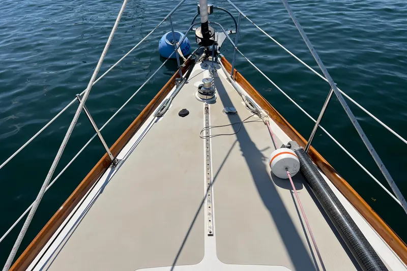 Slide: The Image of Deck view of a 1980 Hinckley 43 sailboat on calm water. - 50