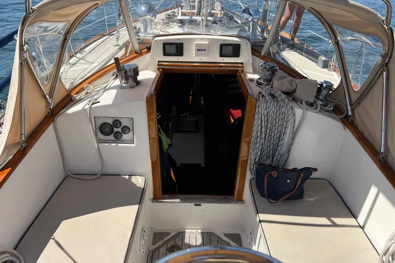 Slide: The Image of Cockpit of a 1980 Hinckley 43 sailboat with seating and navigation equipment. - 55