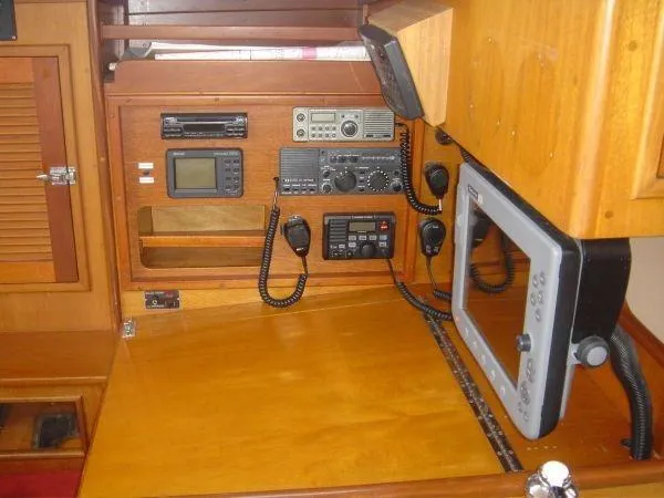Slide: The Image of Navigation equipment inside a 1980 Hinckley 43 boat, featuring radios and control panels. - 9