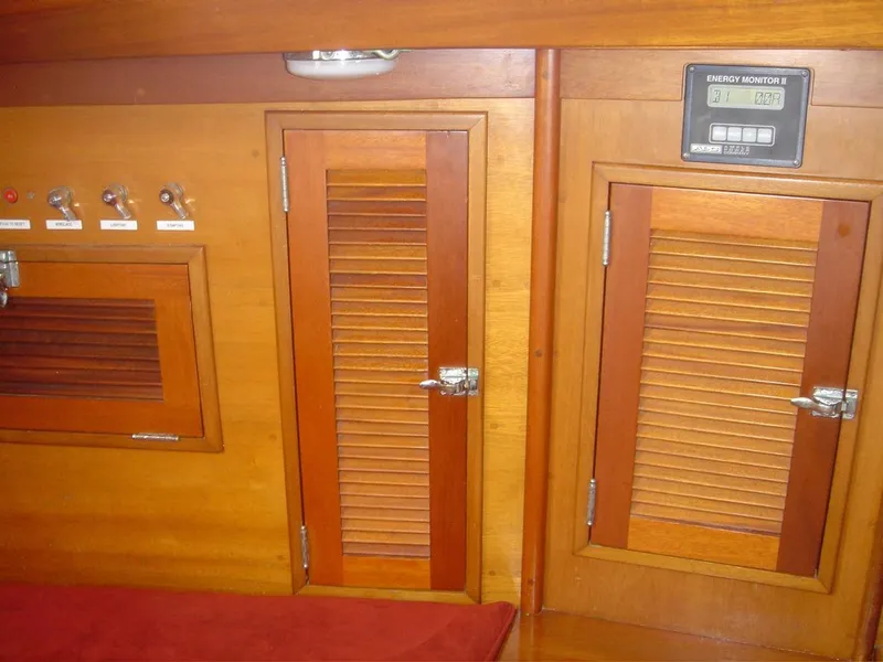 Slide: The Image of 1980 Hinckley 43 interior with wooden cabinets and energy monitor. - 16