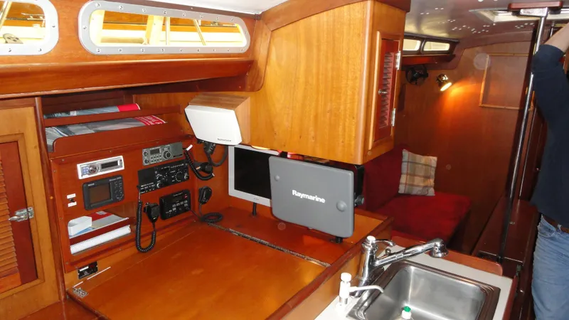 Slide: The Image of 1980 Hinckley 43 yacht interior with navigation equipment and wooden cabinetry. - 23