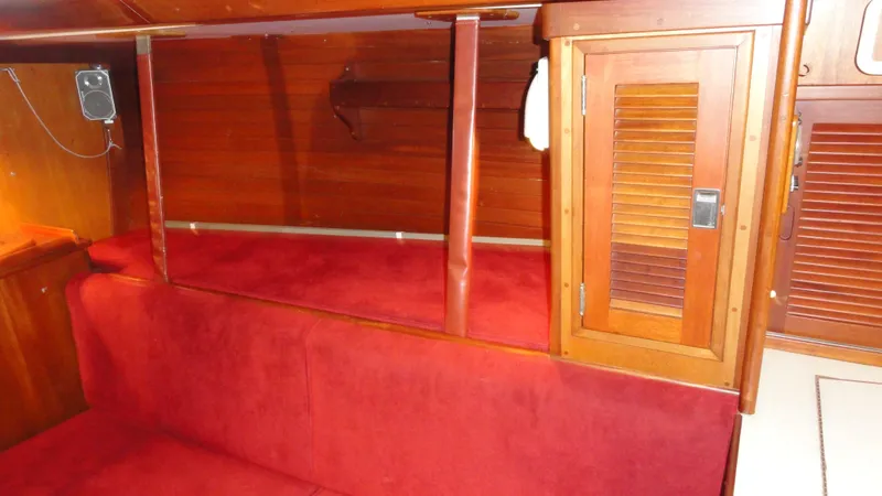 Slide: The Image of Interior of a 1980 Hinckley 43 boat with red seating and wooden cabinetry. - 30