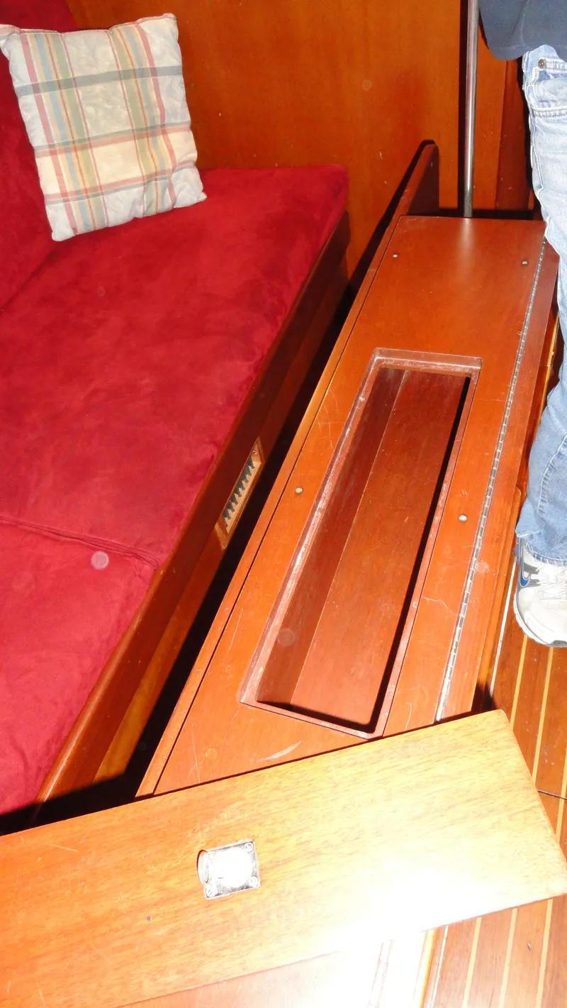 Slide: The Image of Interior of 1980 Hinckley 43 yacht with red seating and wooden flooring. - 31