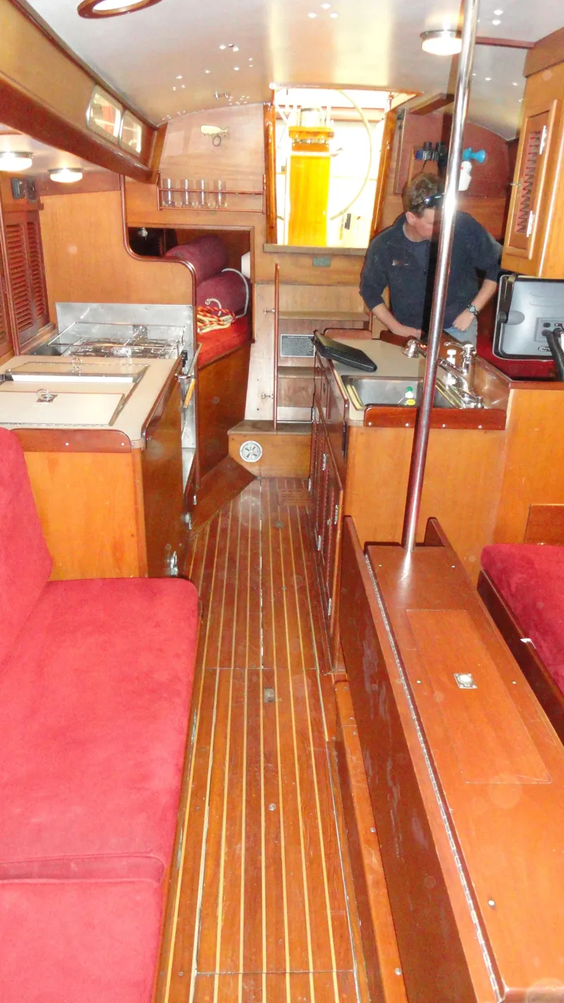 Slide: The Image of Interior of 1980 Hinckley 43 yacht with wood flooring and red seating. - 33