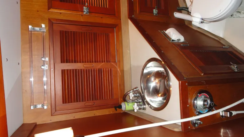 Slide: The Image of Interior of 1980 Hinckley 43 yacht with wooden cabinets and stainless steel sink. - 37
