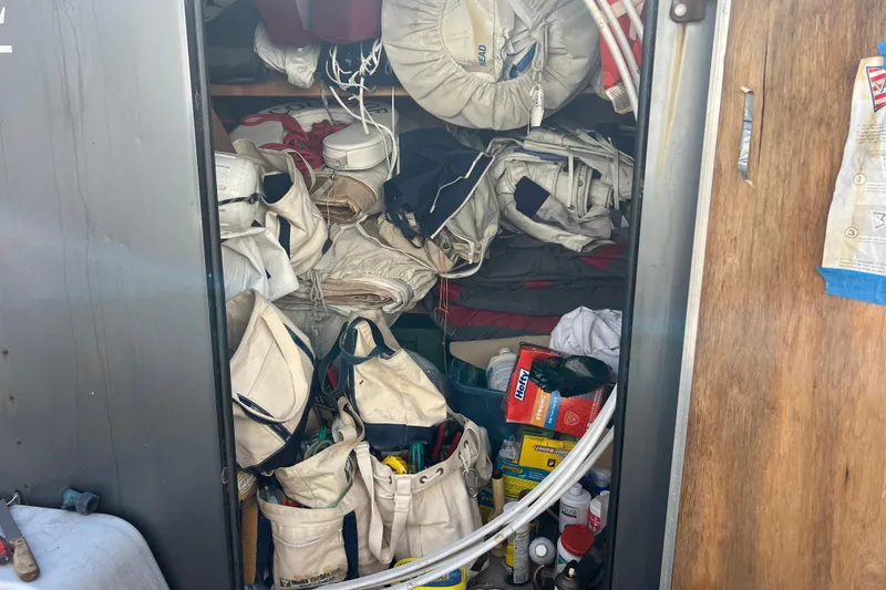 Slide: The Image of Storage compartment filled with sailing gear and supplies on a 1980 Hinckley 43 boat. - 65