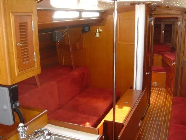 Slide: The Image of Interior of 1980 Hinckley 43 yacht with wooden finish and red seating. - 7