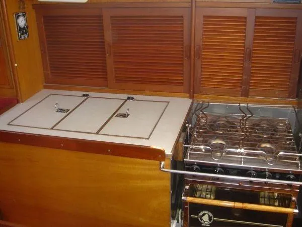 Slide: The Image of 1980 Hinckley 43 yacht kitchen with stove and wooden cabinets. - 8