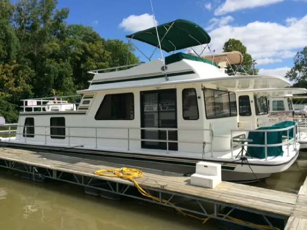 The Image of 1999 Gibson 44 Standard houseboat docked on a sunny day. - 0