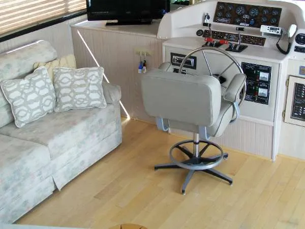 Slide: The Image of Interior of a 1999 Gibson 44 Standard houseboat with helm and sofa. - 10