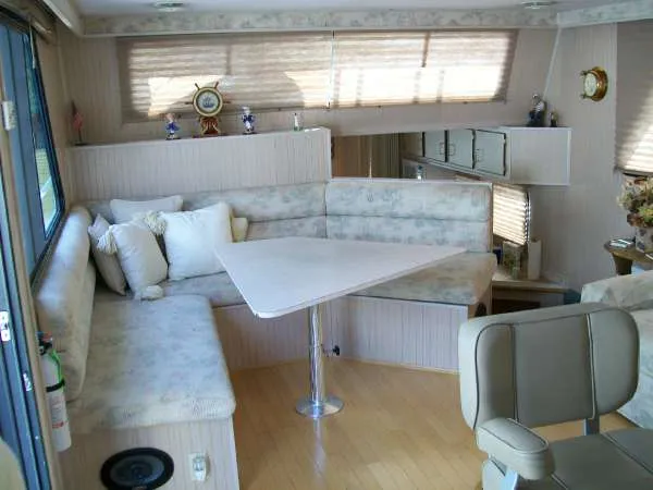 Slide: The Image of Interior of a 1999 Gibson 44 Standard houseboat with seating area. - 8