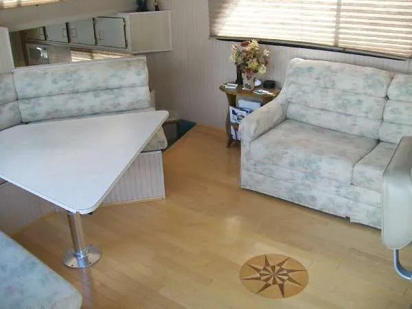 Slide: The Image of Interior of a 1999 Gibson 44 Standard Houseboat with cozy seating area. - 9