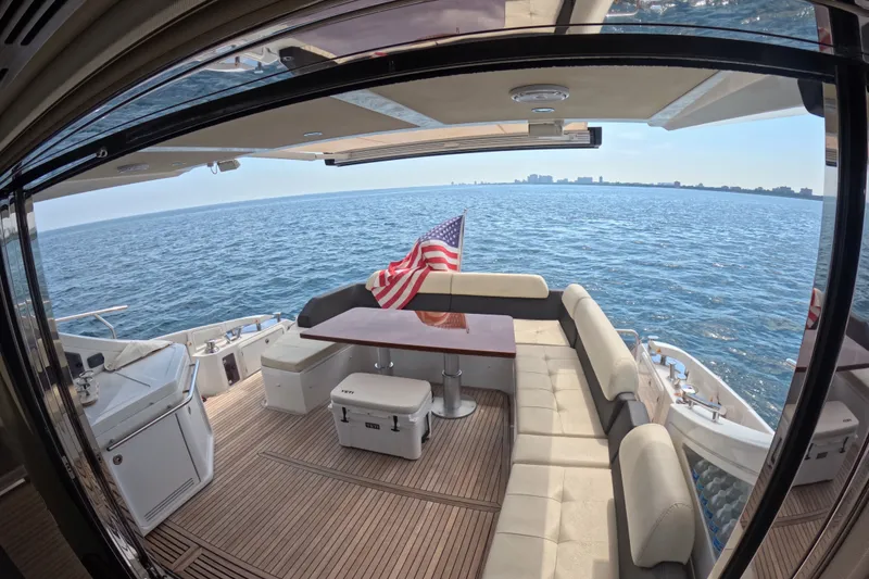 Slide: The Image of Luxurious 2016 Azimut 55S yacht deck with seating, table, and ocean view. - 36