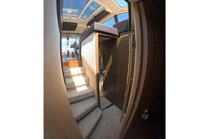 Slide: The Image of Interior view of 2016 Azimut 55S yacht with skylight and carpeted stairs. - 77