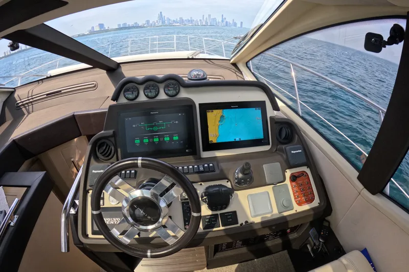 Slide: The Image of Cockpit view of 2016 Azimut 55S yacht with navigation screens and city skyline. - 64