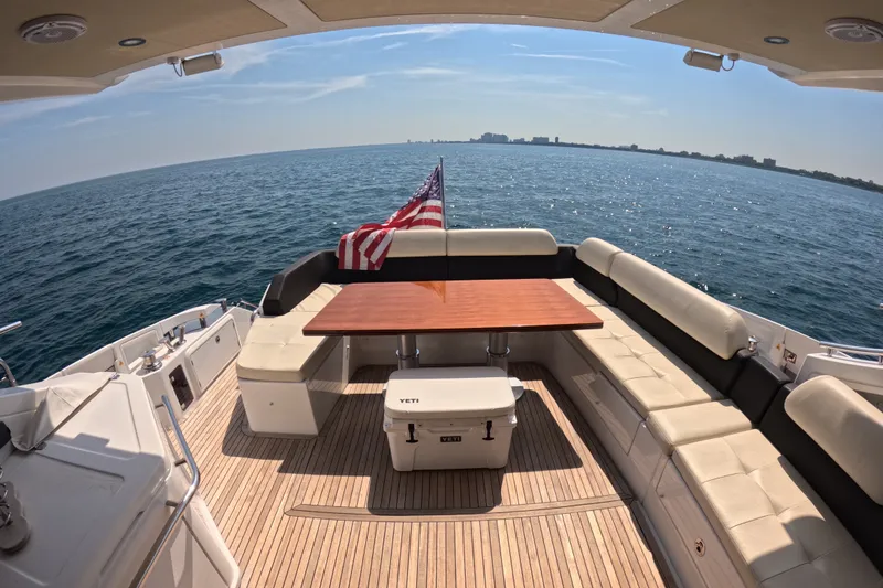 Slide: The Image of Luxurious 2016 Azimut 55S yacht deck with seating, table, and ocean view. - 11