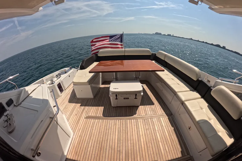 Slide: The Image of Luxurious 2016 Azimut 55S yacht deck with seating, table, and ocean view. - 10