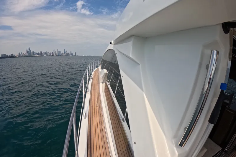 Slide: The Image of Azimut 55S yacht cruising near city skyline, 2016 model, clear skies, calm waters. - 17