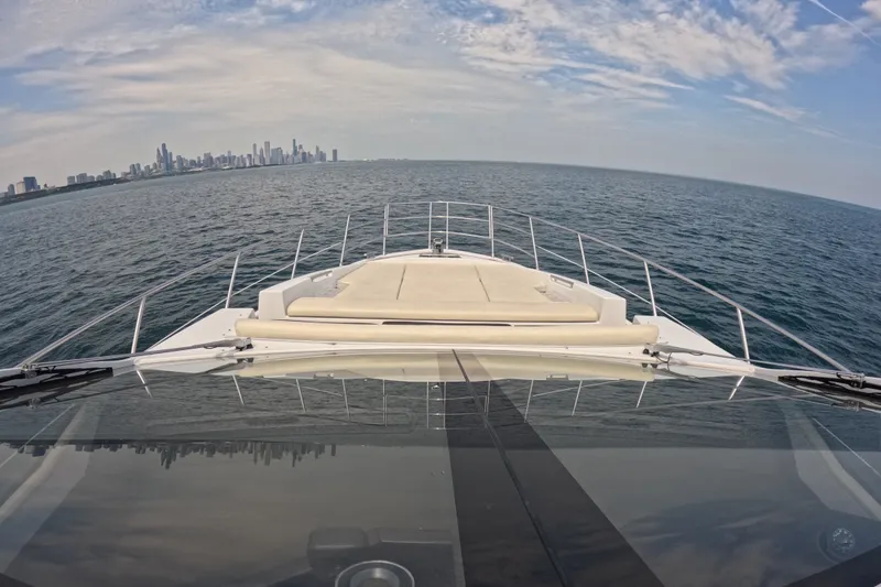 Slide: The Image of Azimut 55S yacht cruising towards city skyline under a partly cloudy sky. - 22