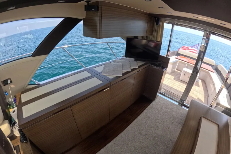 Slide: The Image of Interior of 2016 Azimut 55S yacht with ocean view and American flag. - 46
