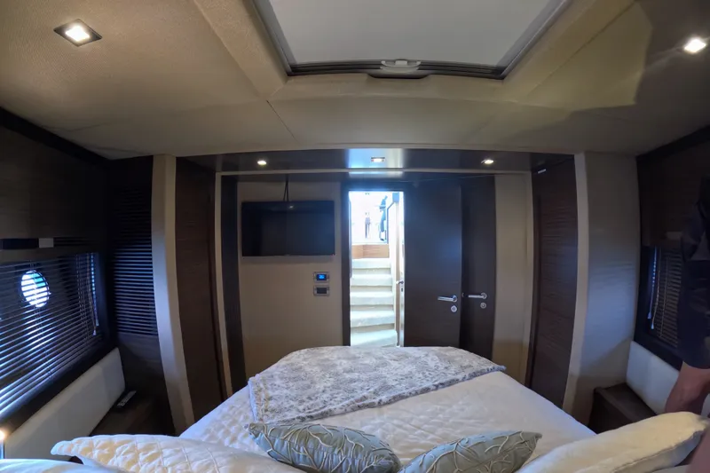 Slide: The Image of Luxurious bedroom interior of a 2016 Azimut 55S yacht, featuring modern design and cozy bedding. - 124