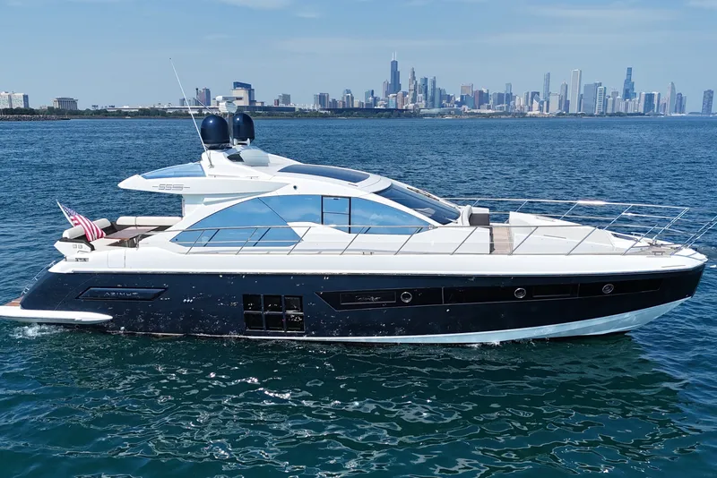 Slide: The Image of Luxury 2016 Azimut 55S yacht cruising near city skyline on a sunny day. - 1