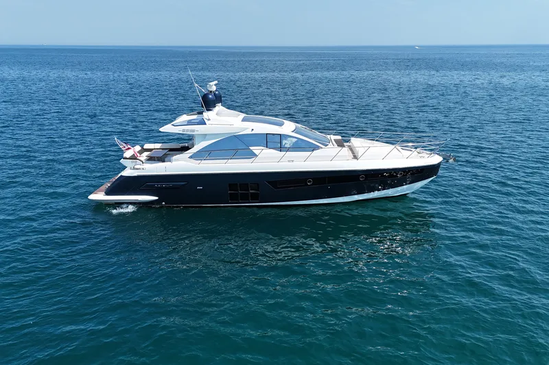 Slide: The Image of 2016 Azimut 55S yacht cruising on open sea under clear blue sky. - 5