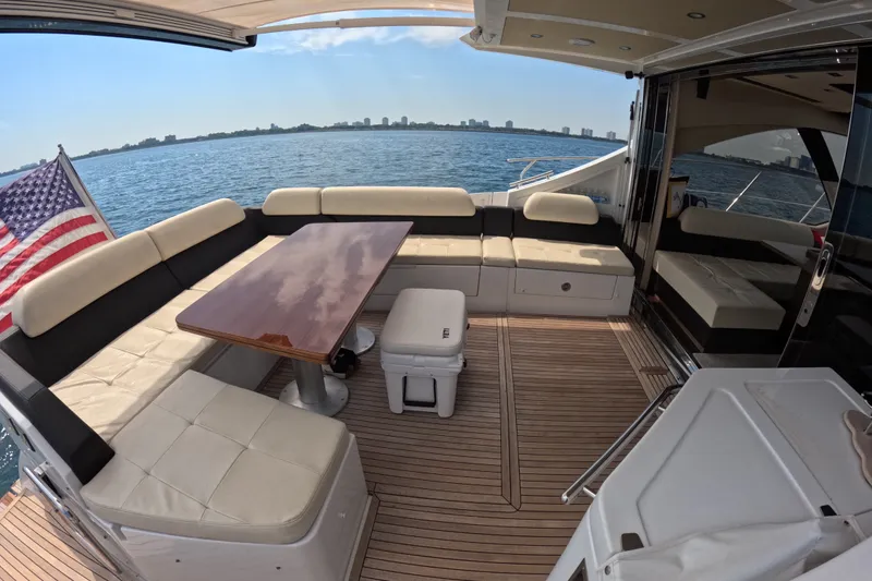 Slide: The Image of Luxurious 2016 Azimut 55S yacht deck with seating, table, and ocean view. - 14