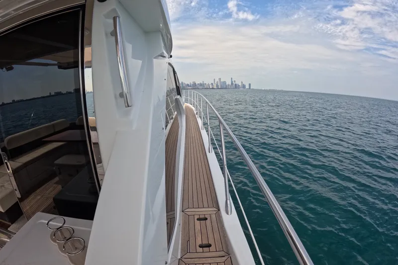 Slide: The Image of Azimut 55S yacht cruising with city skyline in the distance, 2016 model. - 28