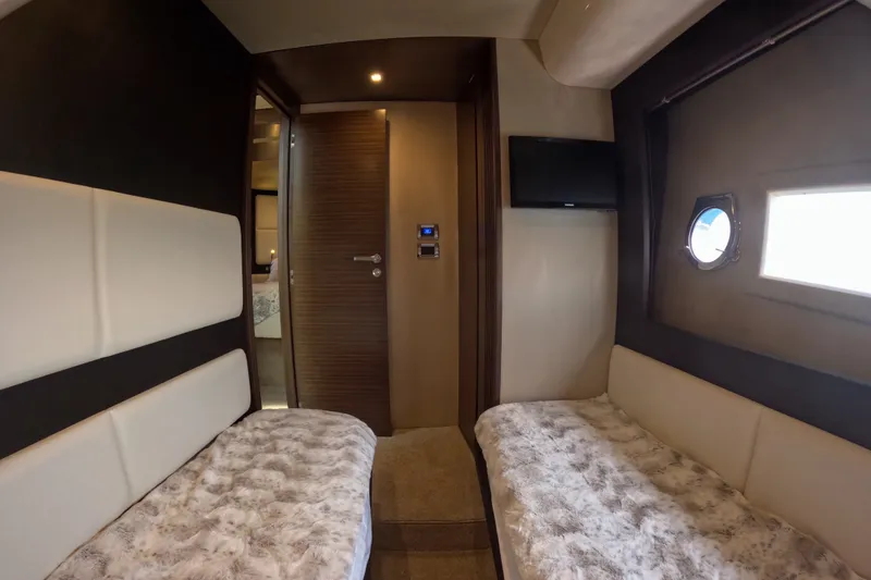 Slide: The Image of Interior of 2016 Azimut 55S yacht cabin with twin beds and porthole window. - 110
