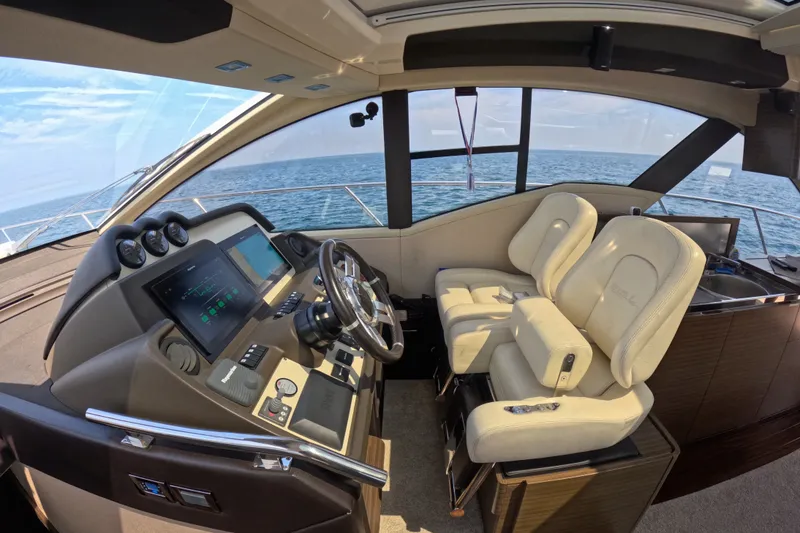 Slide: The Image of Luxurious 2016 Azimut 55S yacht cockpit with modern controls and plush seating. - 62
