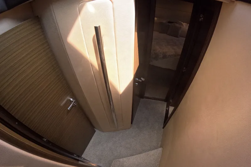 Slide: The Image of Interior hallway of 2016 Azimut 55S yacht, featuring modern design and cozy bedroom entrance. - 111