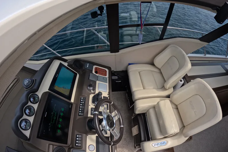 Slide: The Image of Cockpit of 2016 Azimut 55S yacht with dual seats and navigation controls. - 63