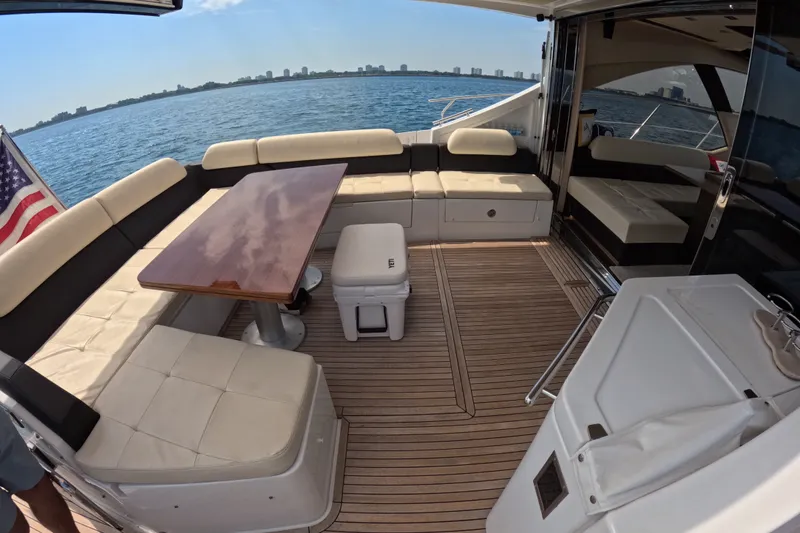 Slide: The Image of Luxurious 2016 Azimut 55S yacht deck with seating, table, and ocean view. - 12