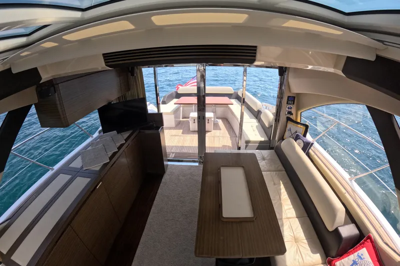 Slide: The Image of Interior view of 2016 Azimut 55S yacht, featuring elegant seating and ocean backdrop. - 56