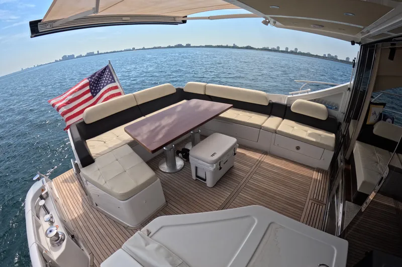 Slide: The Image of Luxurious 2016 Azimut 55S yacht deck with seating, table, and American flag. - 16