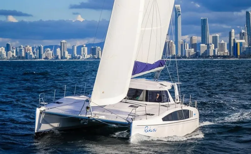 Slide: The Image of 2024 Seawind 1260 Owners Version catamaran sailing near city skyline. - 11