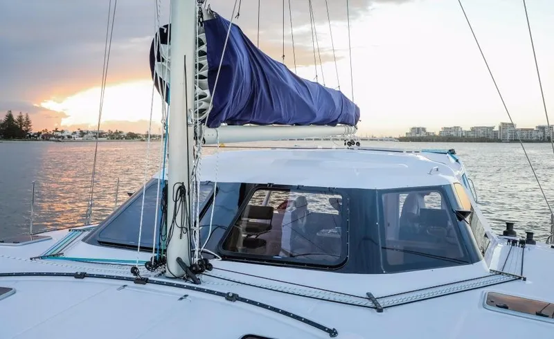 Slide: The Image of 2024 Seawind 1260 Owners Version catamaran sailing at sunset. - 15