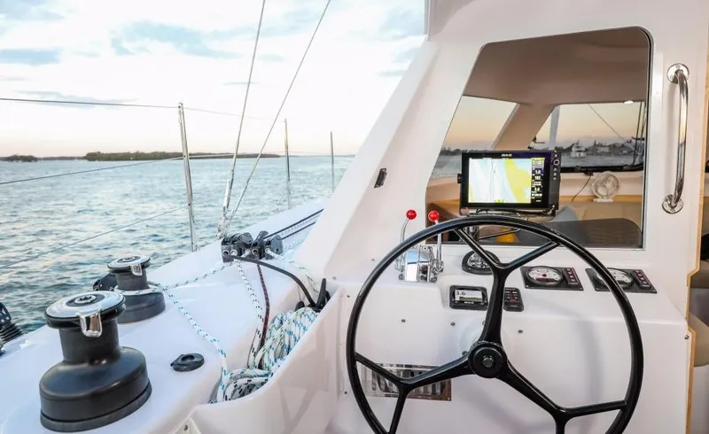 Slide: The Image of 2024 Seawind 1260 Owners Version yacht helm with navigation system on calm waters. - 17