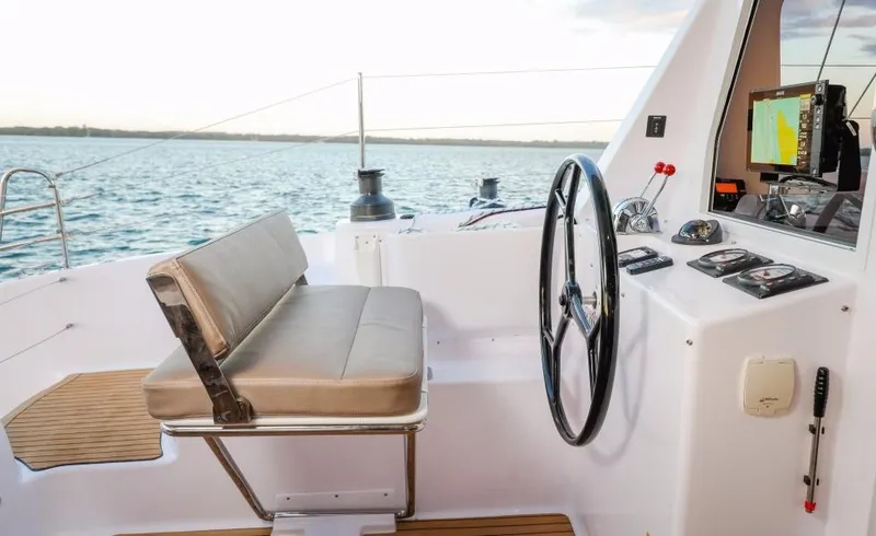 Slide: The Image of 2024 Seawind 1260 Owners Version cockpit with steering wheel and navigation equipment. - 18