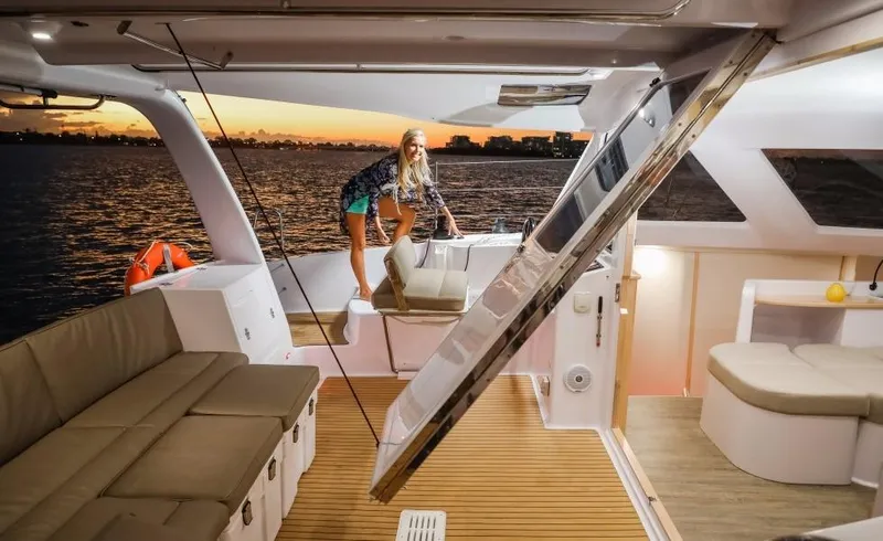 Slide: The Image of 2024 Seawind 1260 Owners Version catamaran interior with sunset view. - 19