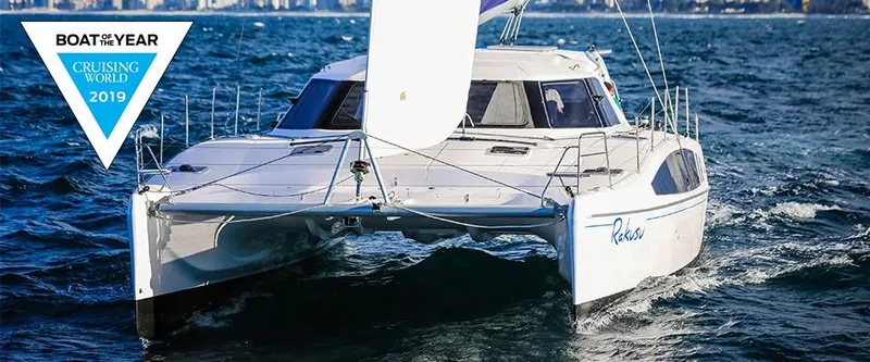 Slide: The Image of 2024 Seawind 1260 Owners Version catamaran sailing on the ocean, awarded Boat of the Year 2019. - 2