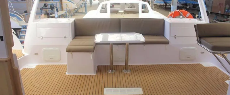 Slide: The Image of 2024 Seawind 1260 Owners Version catamaran with spacious outdoor seating and table. - 21