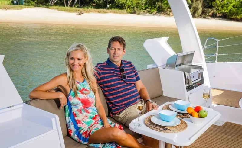 Slide: The Image of Couple relaxing on 2024 Seawind 1260 Owners Version catamaran near beach. - 22