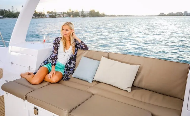Slide: The Image of Woman relaxing on Seawind 1260 Owners Version yacht, 2024 model, with ocean view. - 25