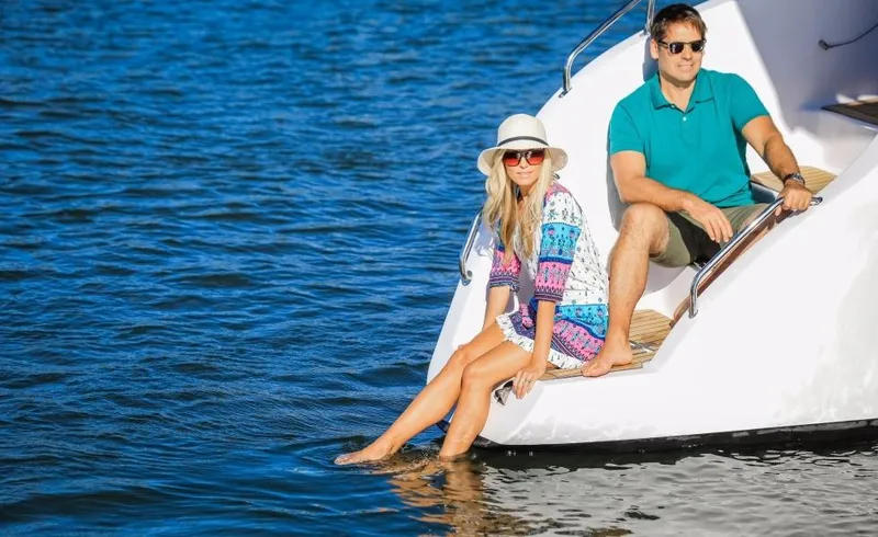 Slide: The Image of Couple relaxing on a 2024 Seawind 1260 Owners Version catamaran. - 26