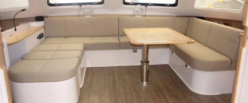 Slide: The Image of 2024 Seawind 1260 Owners Version interior with spacious seating and dining area. - 28